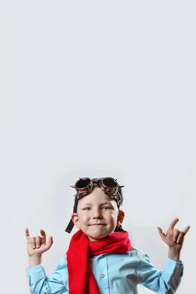 Boy in blue shirt, red scarf, biker glasses and bandana on light background — Stock Photo, Image