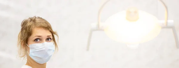 smiling doctor in a bright medical office and a lamp in the foreground