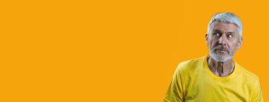 sarı bir arka plan üzerinde sakallı sürpriz ve meraklı gri saçlı adam portresi