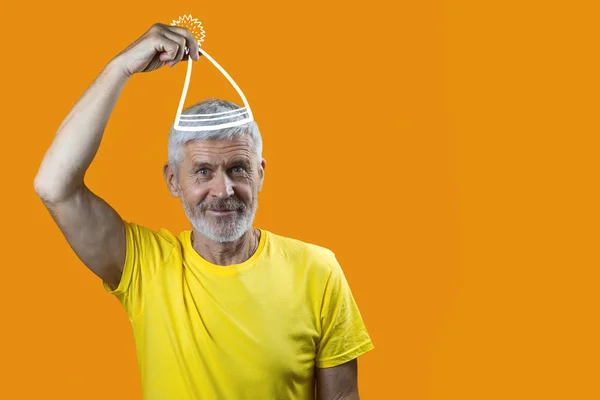 Portrait of a cheerful gray-haired man with a beard and a cap on yellow background — Stock Photo, Image