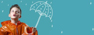 turuncu bir yağmurluk ve boyalı şemsiye ile çocuk yağmur standları