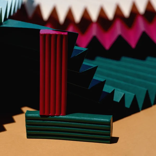 Modern multicolored composition of bars of clay and fans of cardboard. Stylish geometric concept.