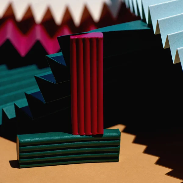 Modern multicolored composition of bars of clay and fans of cardboard. Stylish geometric concept.