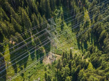 İsviçre 'deki Alp Ormanı' ndan geçen elektrik hattının havadan görüntüsü. Elektrik şebekesi ile elektrik dağıtımı.