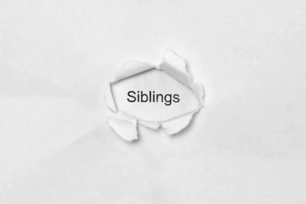Word Siblings White Isolated Background Inscription Wound Hole Paper Stock — Stock Photo, Image