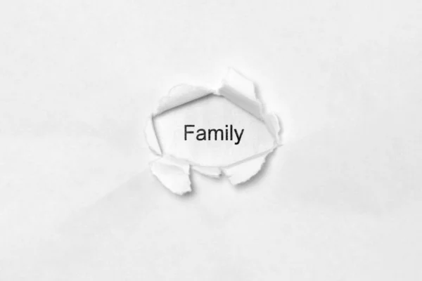 Palavra Família Fundo Isolado Branco Inscrição Através Buraco Ferida Papel — Fotografia de Stock
