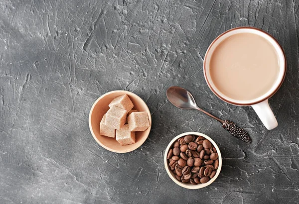 flat white coffee in a cup. brown sugar cubes and coffee beans on a table. relax time. top view.flat lay