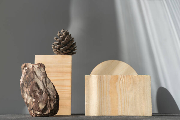 natural wooden podium for product presentation. pedestal or display for advertizing. pine cones and pine bark. geometric podium. Scene with geometrical forms. Empty showcase.