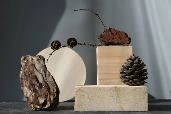 wooden podium for product presentation. pedestal or display for advertizing. variety of pine cones and pine bark. geometric podium. Scene with geometrical forms. Empty showcase. eco friendly design