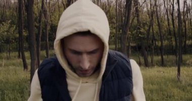 Bir adam parkta yürür ve spora devam etmek için motive olur..