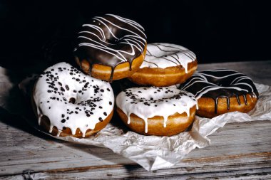 An incredibly tempting display of beautifully decorated donuts topped with both white and dark delicious icing
