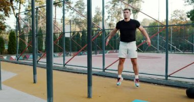 An energetic dynamic exercise session expertly showcasing various jumps and squats in a beautiful outdoor environment