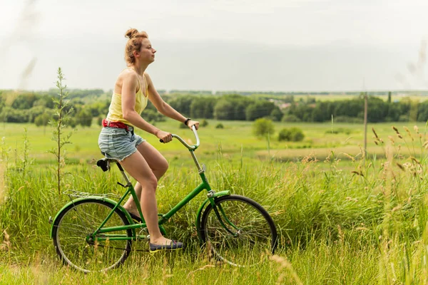 Młoda Piękna Ładna Kobieta Jeździ Rowerze Wiosce Pobliżu Zielonego Pola — Zdjęcie stockowe