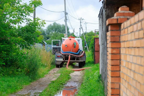 A Sewage truck working in village environment