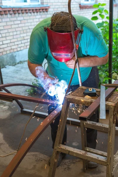Welding at home. A prerequisite for safety precautions is a welder\'s mask.