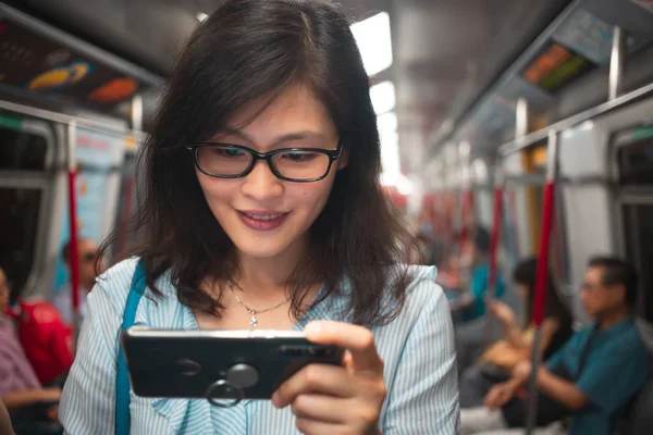 年轻女子在火车内使用智能手机 — 图库照片