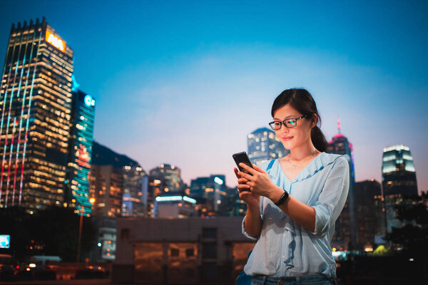Girl use smartphone in Hong Kong City