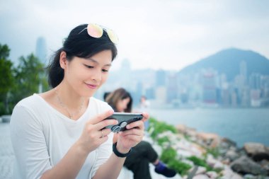 Asyalı kadın Hong Kong şehirde Smartphone kullanarak