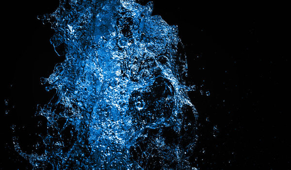 colored water splashes on black background 