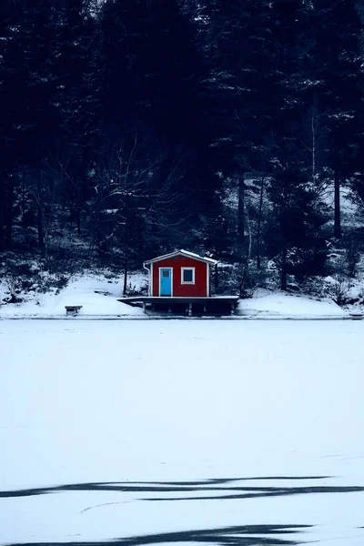 Sweden house in the wintertime. Nature on the shore of the fjord