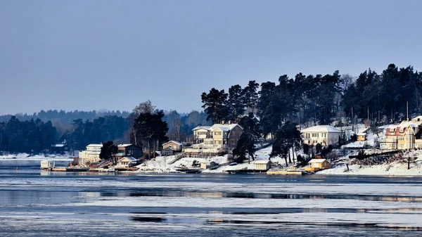 Sweden house in the wintertime. Nature on the shore of the fjord