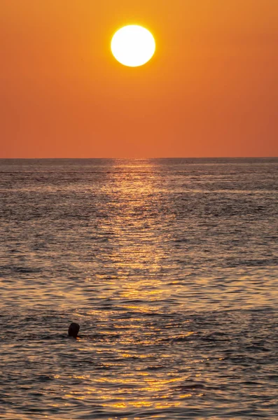 sunset on the sea, the sun sets in the water