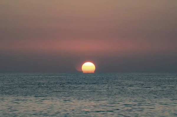 sunset on the sea, the sun sets in the water