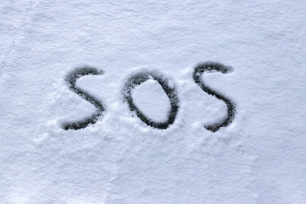 "SOS"geschreven in de sneeuw — Stockfoto