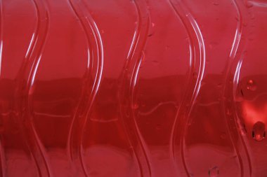 Beyaz arka planda kırmızı plastik şişe