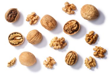 Walnuts (Juglans regia seeds), whole, shelled, halves and partially cracked, top view clipart