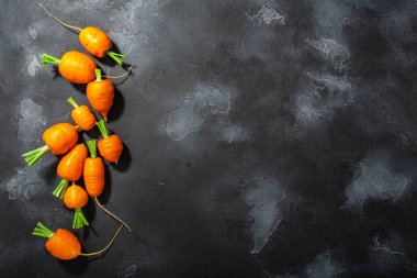Kısa Rondo havuçları koyu dokulu arkaplanda fotokopi alanı, üst görünüm