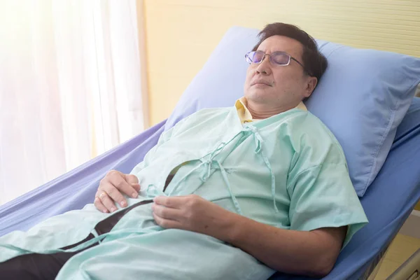 Male patient sleeping treat symptoms on bed at hospital