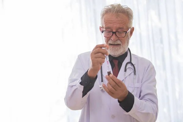 Senior male doctor using syringe Injection for patients.