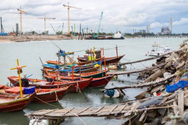 Fishing boats of the villagers Parked at the pier. clipart