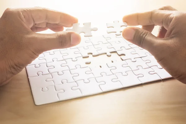 hands of man jigsaw puzzle connecting. copy space.