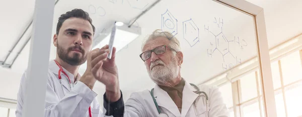 two doctors looking data through mirror. writing medical education project in research room and experiment.