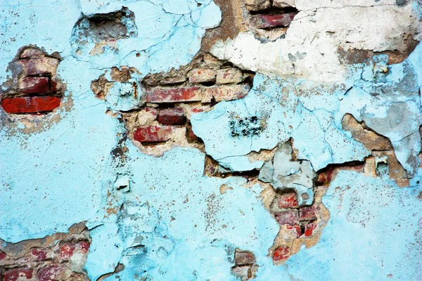Old blue red brick wall. Abstract background and texture of cracked bricks and blue painted wall. Minimalist abstract painting. Art background spots paint. Abstract art spots of paint. Space for text.