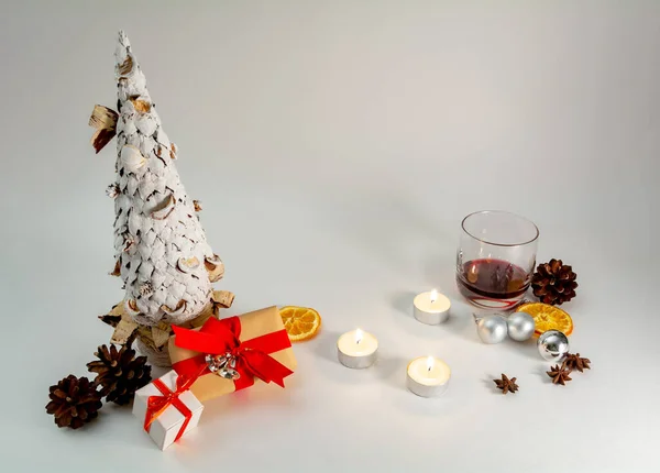 Christmas table decoration banner. White hand made fir. Craft paper red gift boxes recycle nature materials candles lights glass white background. Minimalist new year Xmas concept copy space mockup