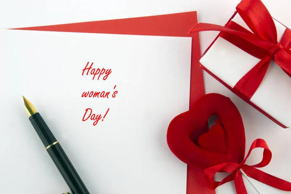 International Women\'s Day, March 8. Red white cards with pen and decorative items, roses, hearts, chocolates, gift box on a white background.