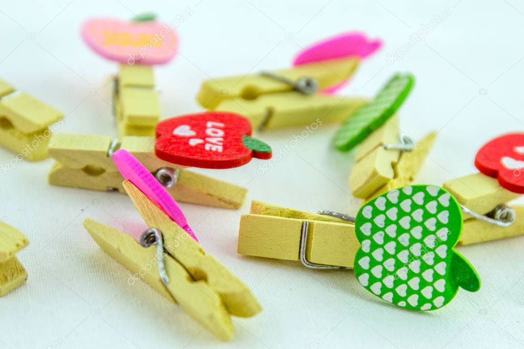 Miniature, wooden, colorful pegs isolated on a white background. Top view.