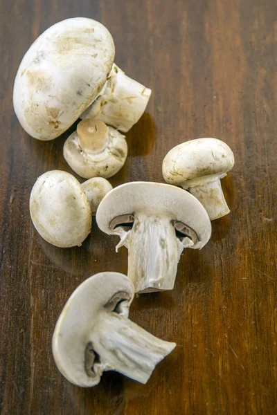It\'s time to cook! Fresh mushrooms with spices on a wooden base