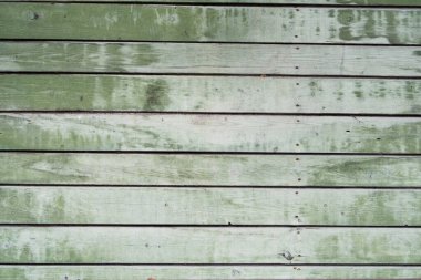 Duvarda yeşil boya izleri, girdaplar, çivi şapkaları, arka plan