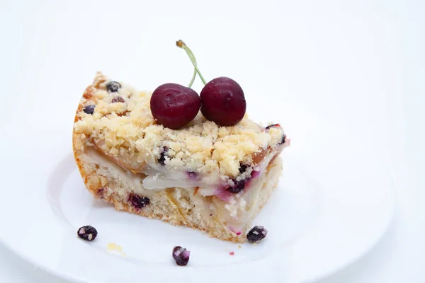 Slice of pear and berry pie garnished with sweet cherry berries