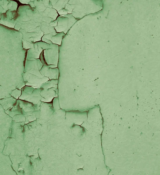 Peeling light paint, underneath a rusty surface of a steel sheet, background