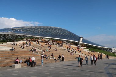 Moskova - 2 Ağustos 2020. Bir sürü insan Zaryadye Parkı 'ndaki saydam çatılı ahşap platformda dinleniyor.