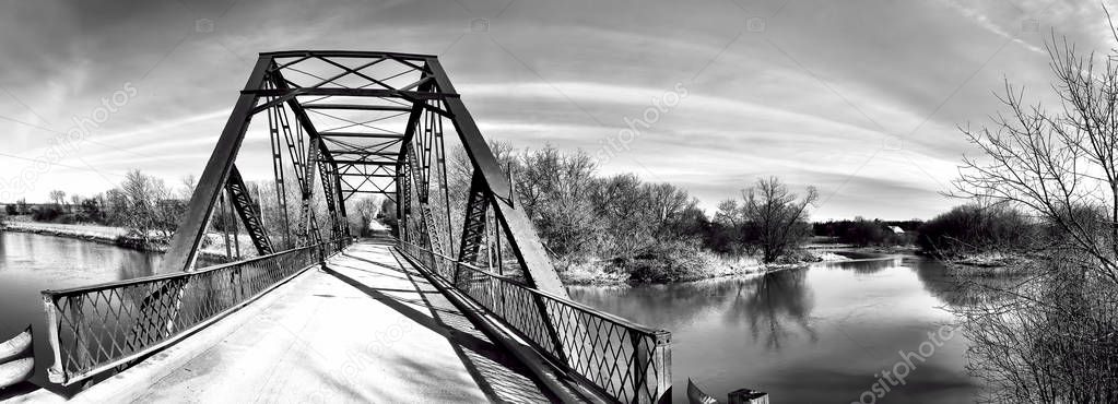 A Panorama of an old iron bridge in black and white