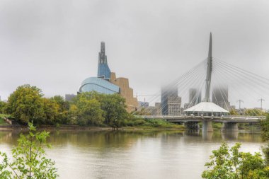 Museum for Human Rights and Bridge in mist in Winnipeg clipart