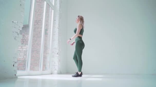 Спортивная Женщина Зеленом Платье Подходит Окну Большой Белой Студии Холле — стоковое видео
