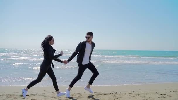 미모의 관광객들이 해변을 행복하게 달리고 배경에 남자와 선글라스를 — 비디오