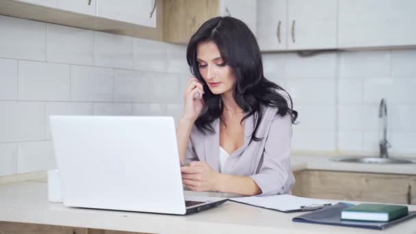 Busy Attractive Brunette Girl Working Kitchen Talking Phone Laptop Notebooks — Stock Video
